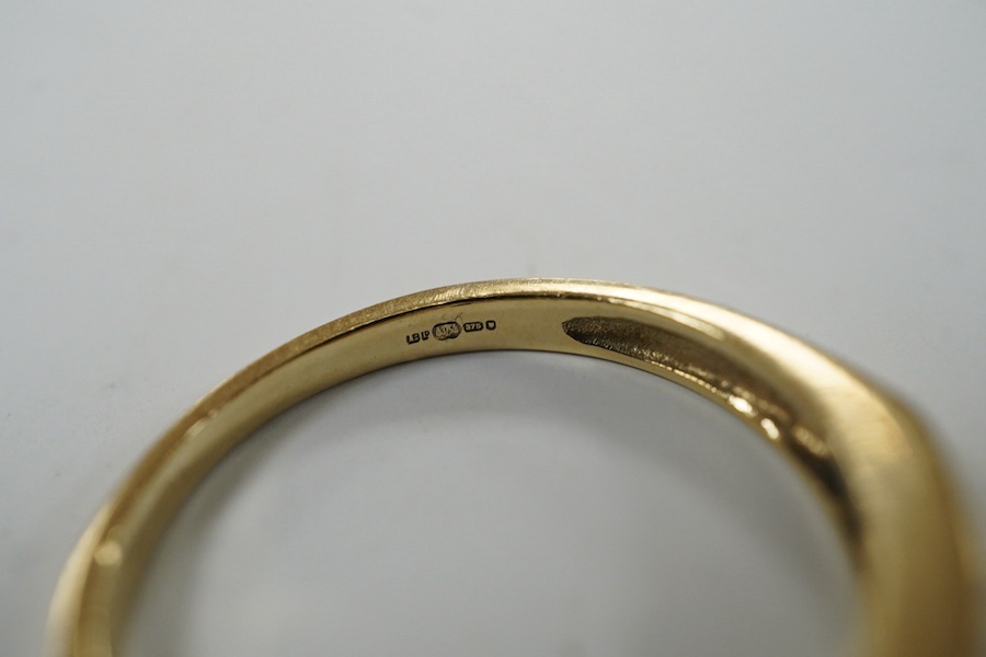 A modern 9ct gold and channel set sapphire and diamond set half hoop ring, size N/O, gross weight 2.2 grams. Condition - fair